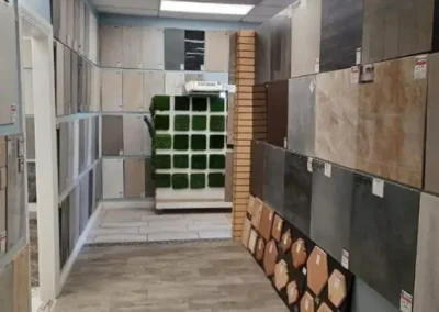 An interior view of a tile store showcasing a variety of tile samples on display walls